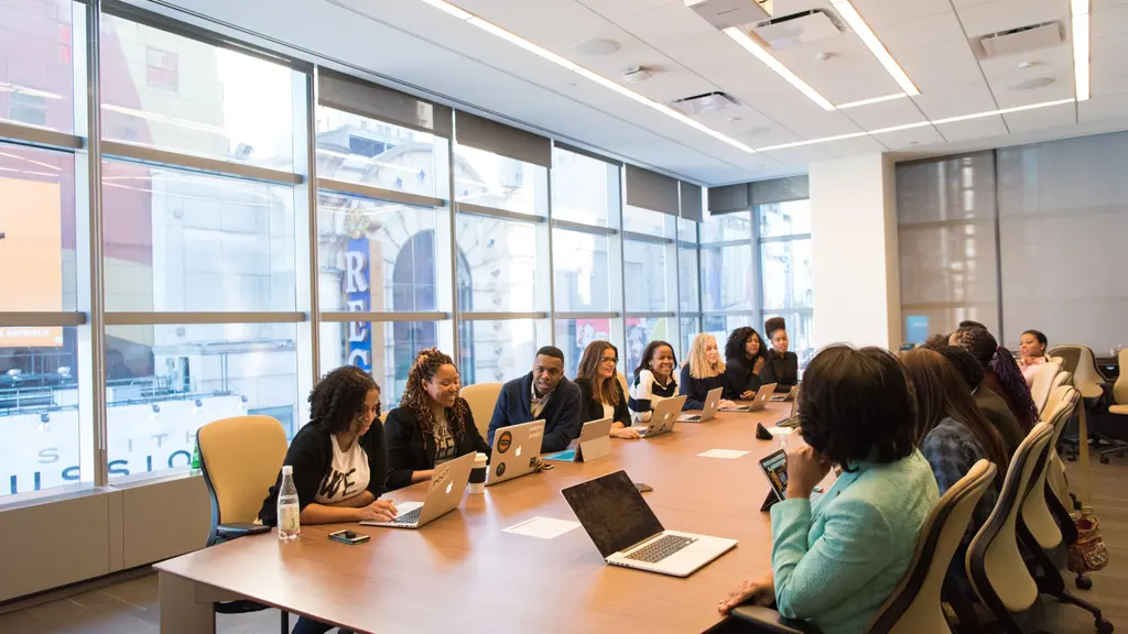 A diverse team collaborating around a table in a modern boardroom.
